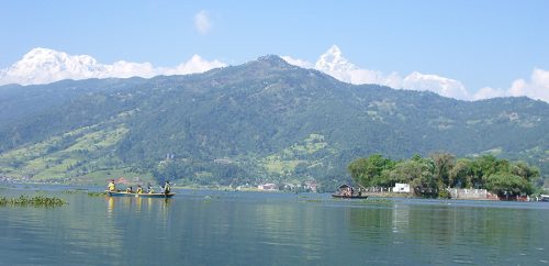 Lush green surroundings with mountains in the background