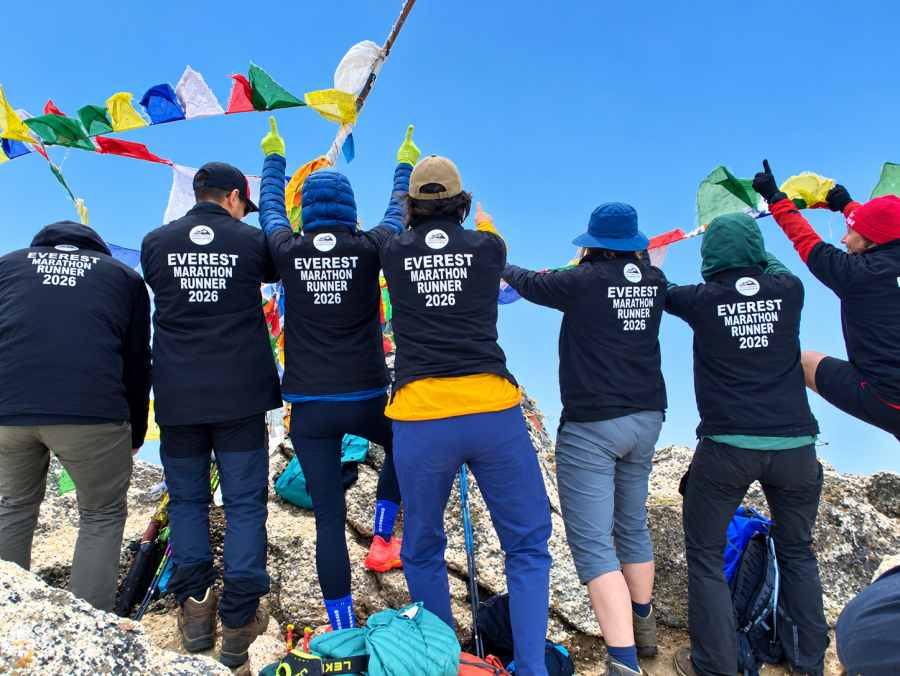 Everest Marathon 2026 runners celebrating at a Himalayan viewpoint