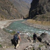 Trekking in Nepal on the 9-day Manaslu Trek with stunning views of Manaslu peak and alpine forests.