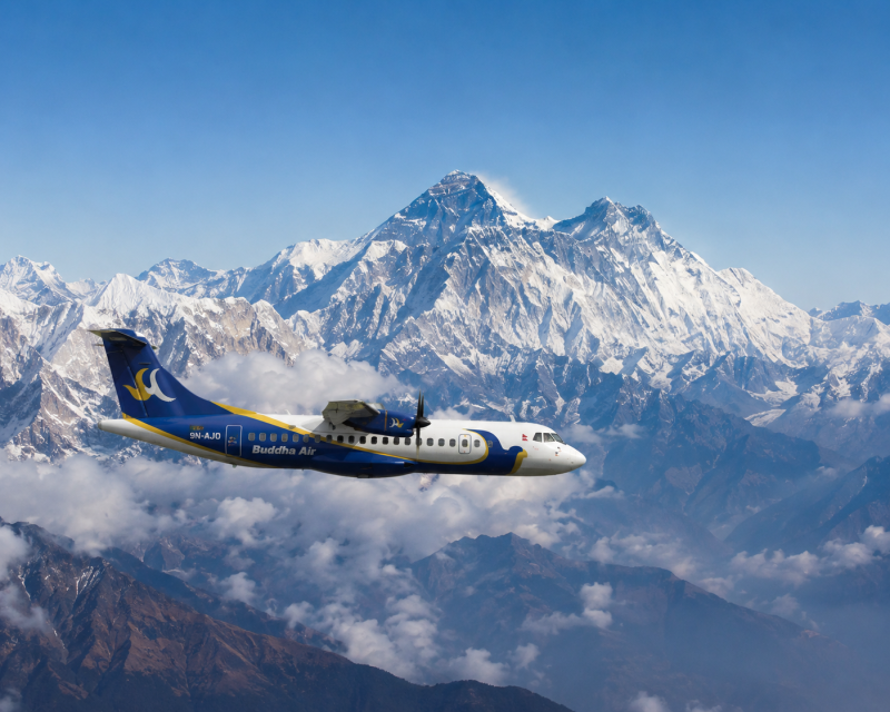 Airplane flying over the Himalayas on an Everest Mountain Flight Tour in Nepal with views of Mount Everest and snow peaks.