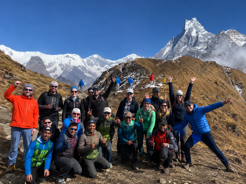 Mardi Himal Trek group photo at Mardi Himal View Point with Annapurna South, Hiunchuli, and Machhapuchhre mountains in the background.