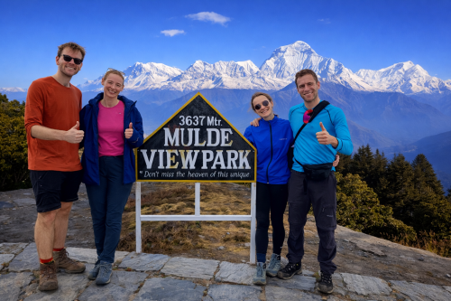 Trekker standing at Mulde Peak with panoramic views of the Himalayas.