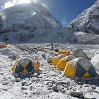 Overnight camping experience at Everest Base Camp surrounded by snow-covered peaks.
