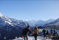 Three Canadian trekkers enjoying the Mardi Himal Trek and Chitwan Jungle Safari in Nepal during a 7-day adventure, surrounded by Himalayan mountain scenery and lush jungle landscape.