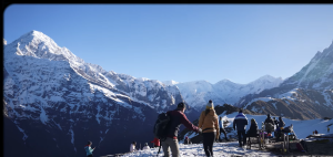 Three Canadian trekkers enjoying the Mardi Himal Trek and Chitwan Jungle Safari in Nepal during a 7-day adventure, surrounded by Himalayan mountain scenery and lush jungle landscape.