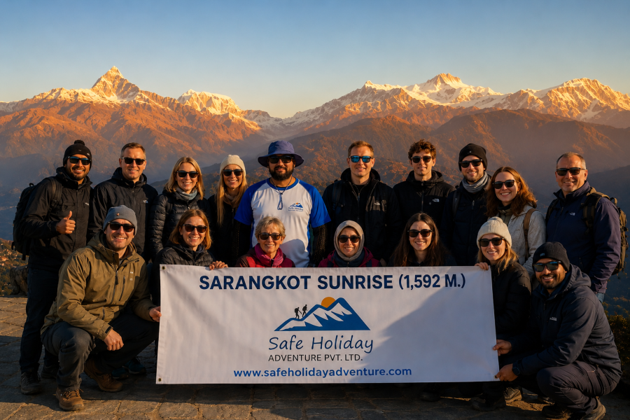 Tourists and Nepali guide posing beneath golden Sarangkot sunrise peaks-