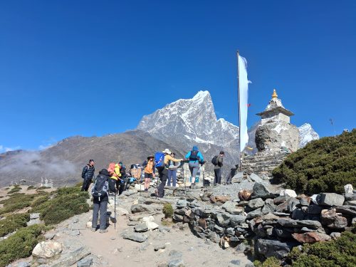 Everest Base Camp trek trail with stunning Himalayan views, trekkers, mountains, and scenic landscapes in Nepal.