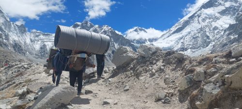 Porter carrying heavy load at Lobuche